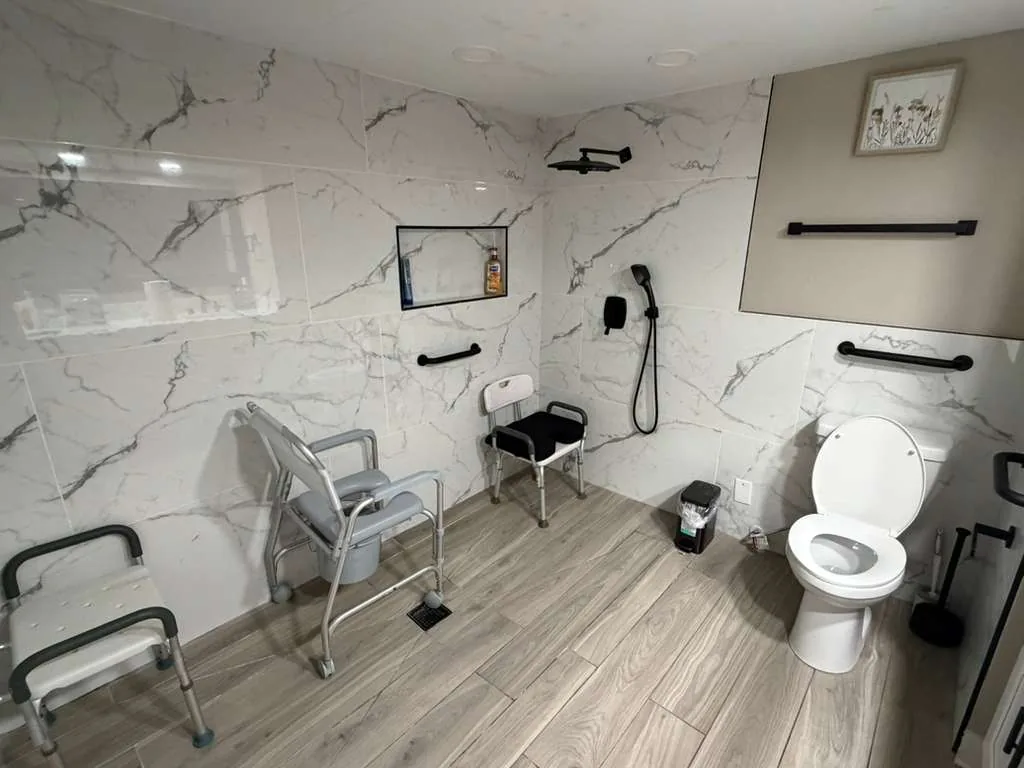Accessible bathroom at Comfort Cove with grab bars and walk-in shower
