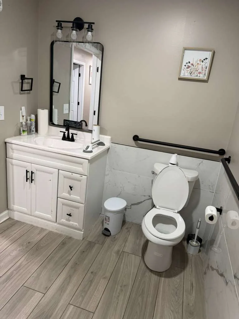 Comfort Cove bathroom with accessible vanity and toilet grab bars