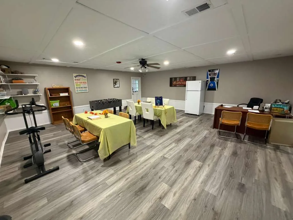 Comfort Cove activity room with tables, games and open space for resident activities.