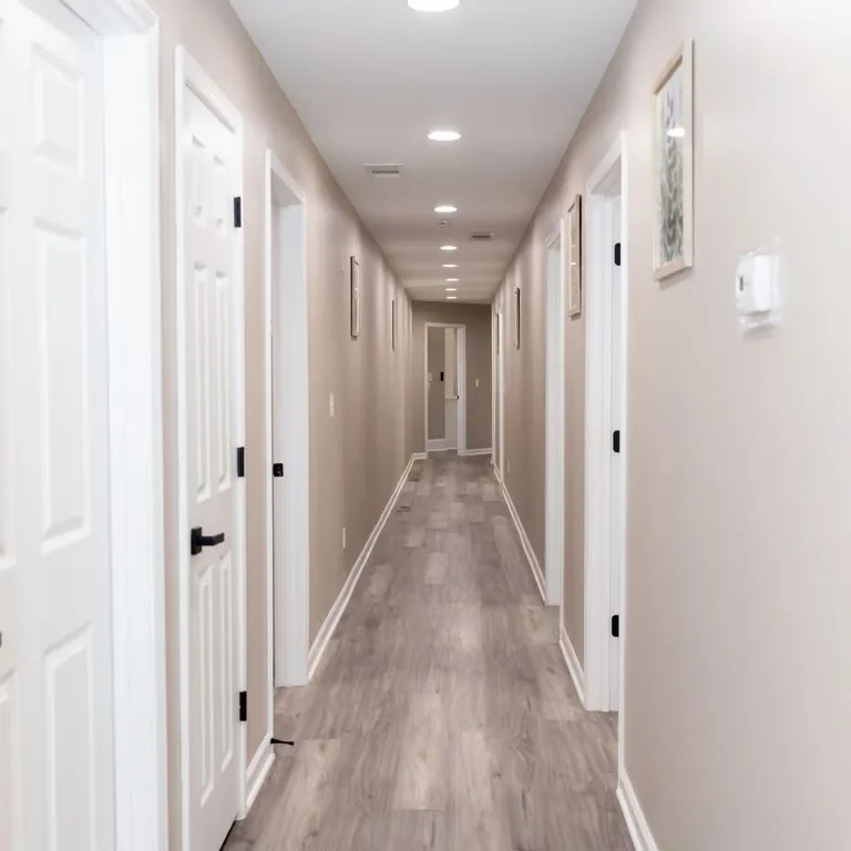 Bright hallway connecting resident rooms and common areas.
